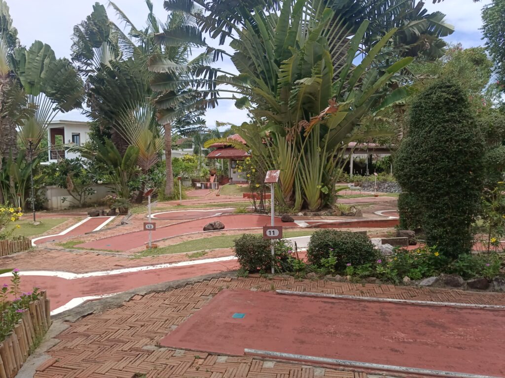 tropical plants and creative obstacles on mini golf course samui